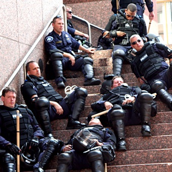 Riot cops relax after beating protesters at the RNC.